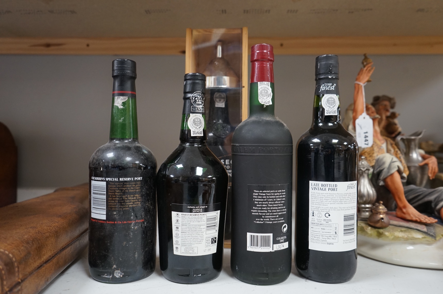 Five assorted bottles of port, including a boxed Fonseca 1988, a bottle of Calem 1987 and three other bottles of port.